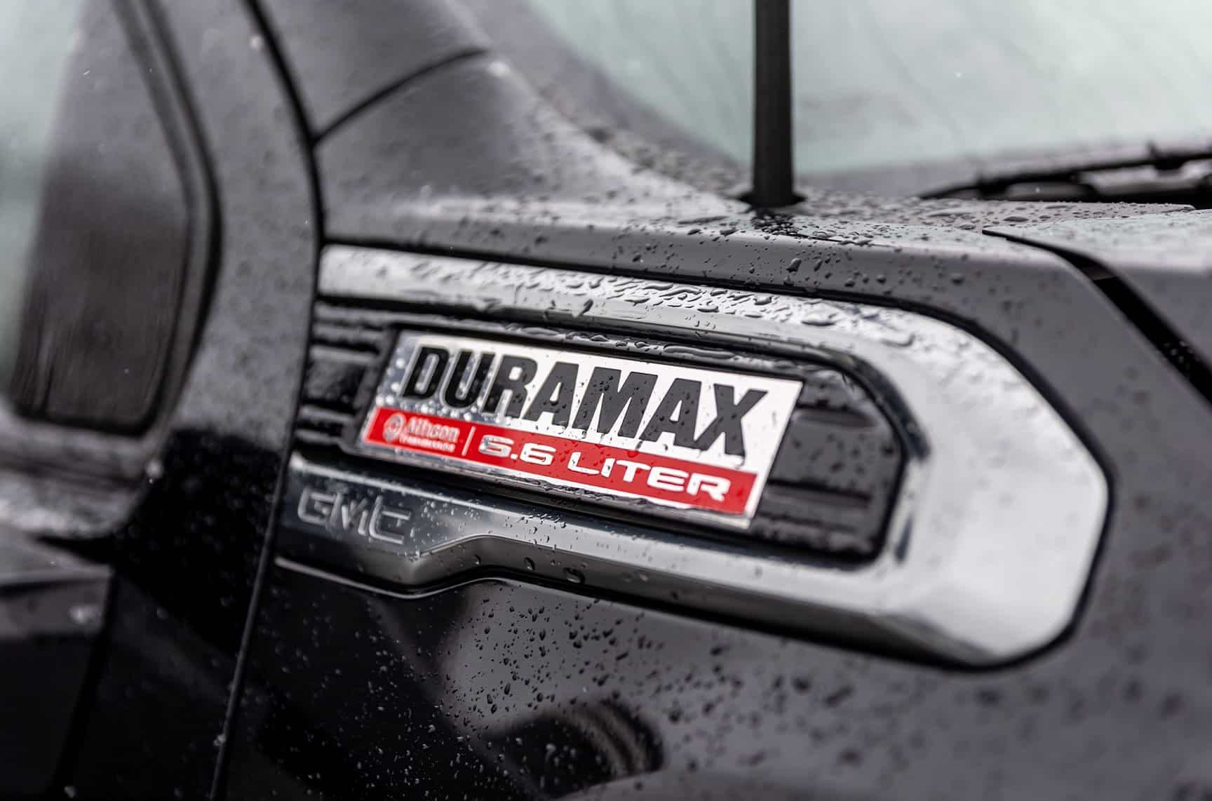 A close up of a Duramax trademark of a black 2020 GMC Sierra pickup truck.